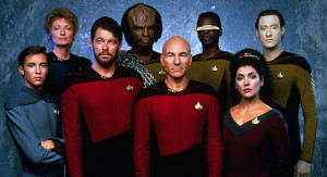 cast of Star Trek: The Next Generation standing in front of a blue background