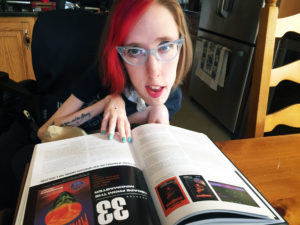 Erin reading the book, looking up at the camera