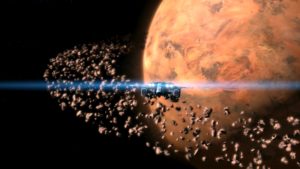 Screen grab of JULIA Among the Stars, a ship headed toward an orange planet surrounded by rocks field 