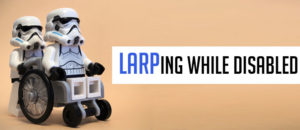 LARPing while Disabled. Two Storm Troopers, one in a wheelchair being pushed by the other
