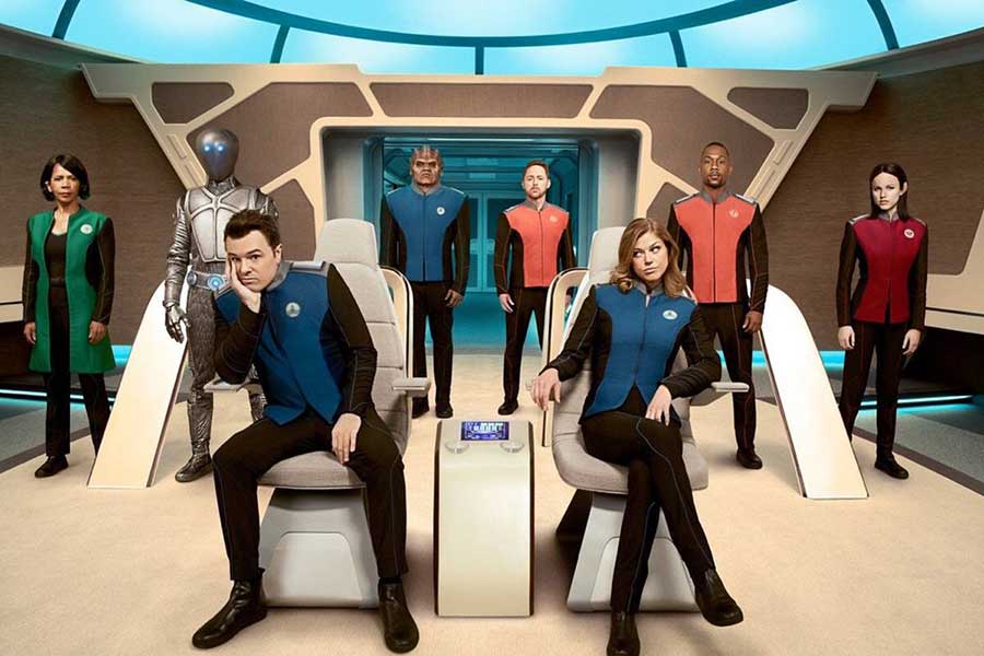 Picture of the crew on the bridge of a spaceship. Seth McFarlane sits in the captain chair, smirking