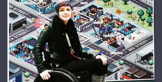 Cherry in their wheelchair in front of a map display for a game