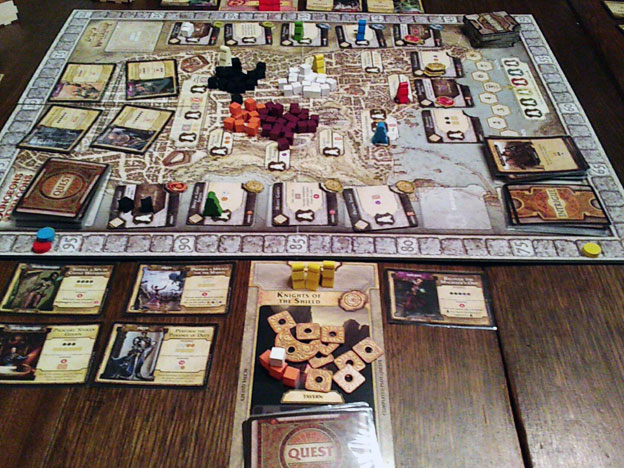 Lords of Waterdeep game on a table, lots of cards with a medieval look and a large board