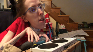 Erin, a visibility disabled woman, uses an xbox adaptive controller