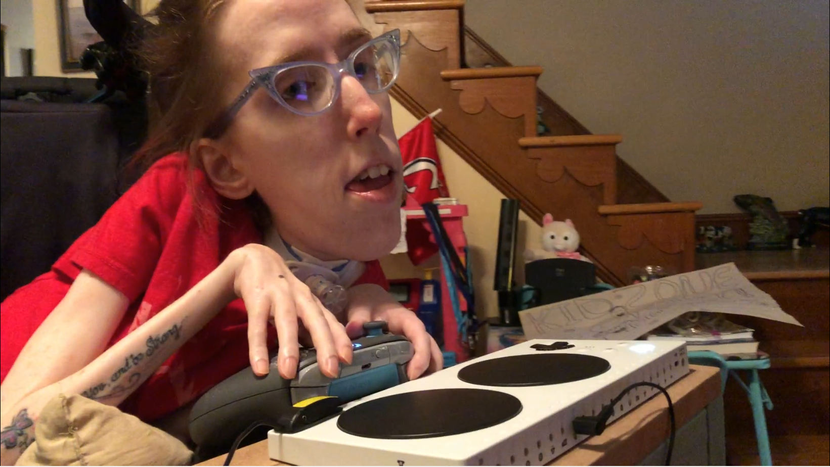 Erin, a visibility disabled woman, uses an xbox adaptive controller